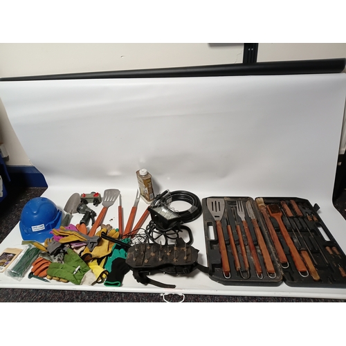 89 - A large collection of gardening equipment, to include a barbecue set, gloves, hard hat, Danish oil a... 