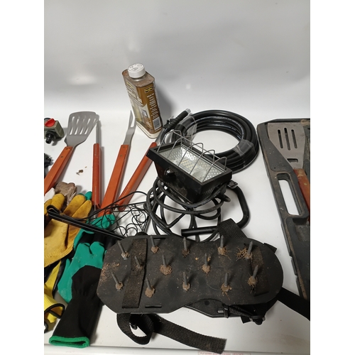 89 - A large collection of gardening equipment, to include a barbecue set, gloves, hard hat, Danish oil a... 