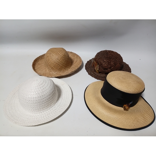277 - A collection of 4 straw hats to include colours such as, white and brown.