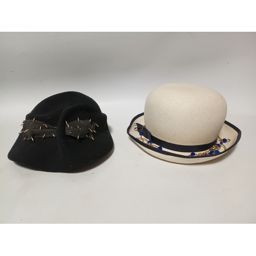279 - A 1920s style Past Times white straw cloche hat and a black felt hat with seed pearls and black brai... 
