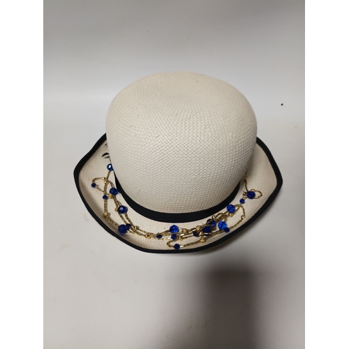 279 - A 1920s style Past Times white straw cloche hat and a black felt hat with seed pearls and black brai... 