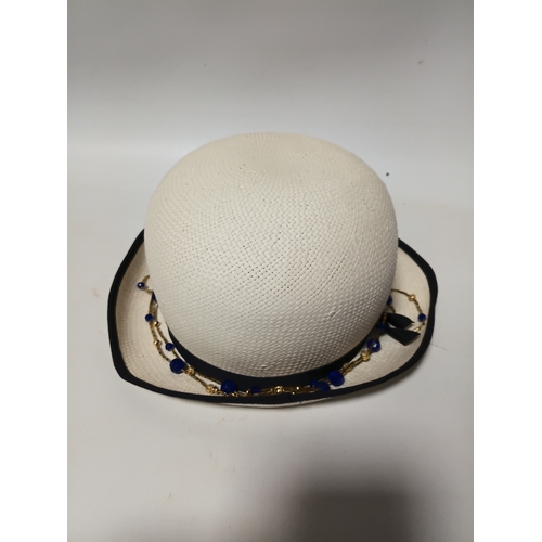 279 - A 1920s style Past Times white straw cloche hat and a black felt hat with seed pearls and black brai... 
