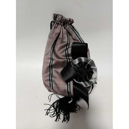 281 - A vintage-style decorative hat featuring black feathers and a striped bow plus a matching bag.