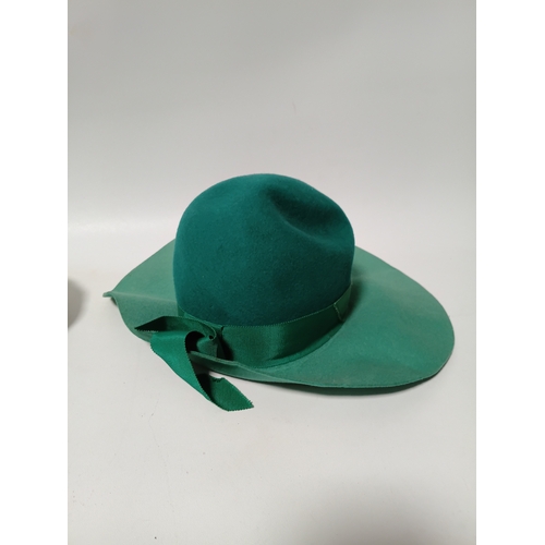 282 - A collection of 4 hats, to include, a white embroidered cap featuring a floral pattern,  a green fel... 