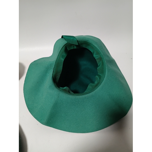 282 - A collection of 4 hats, to include, a white embroidered cap featuring a floral pattern,  a green fel... 