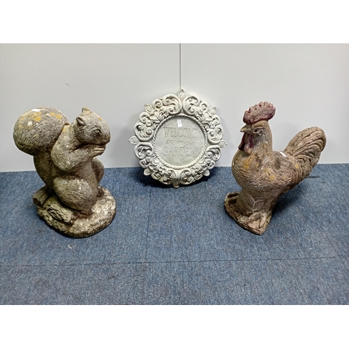 93 - Decorative concrete garden figures of a rooster and squirrel along with an ornamental plaque