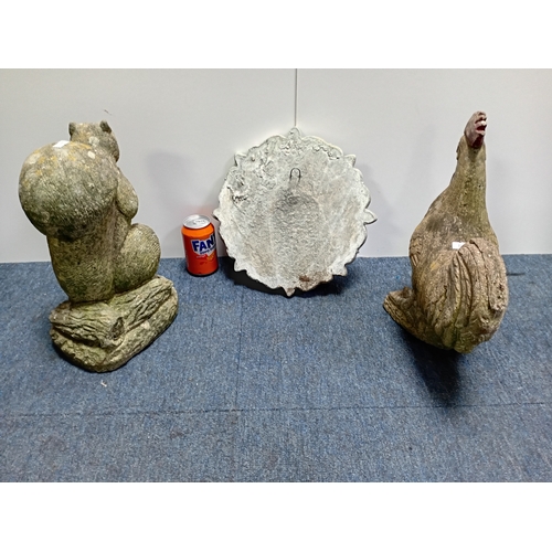 93 - Decorative concrete garden figures of a rooster and squirrel along with an ornamental plaque