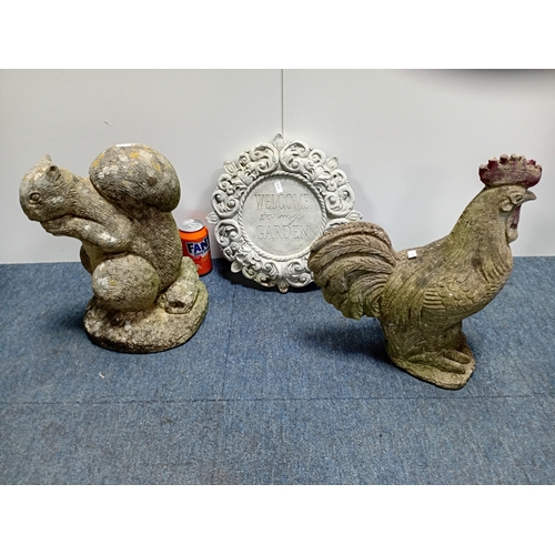 93 - Decorative concrete garden figures of a rooster and squirrel along with an ornamental plaque