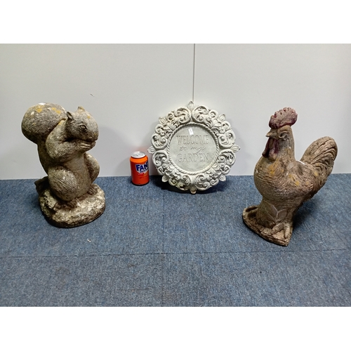 93 - Decorative concrete garden figures of a rooster and squirrel along with an ornamental plaque