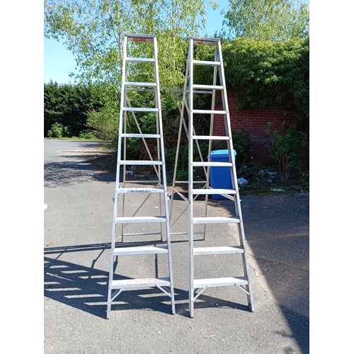 96 - A pair of Titan step / swing-back ladders. (Height 87 inches x total length 106 inches)