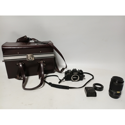 194 - A vintage Minolta X-700 film camera body, with a vintage manual focus zoom lens, specifically a Tou ... 