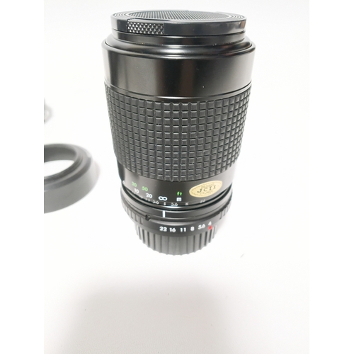 194 - A vintage Minolta X-700 film camera body, with a vintage manual focus zoom lens, specifically a Tou ... 