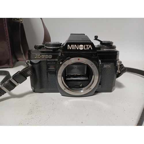 194 - A vintage Minolta X-700 film camera body, with a vintage manual focus zoom lens, specifically a Tou ... 