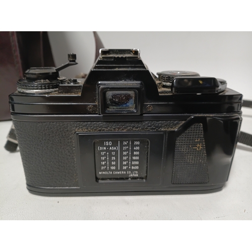 194 - A vintage Minolta X-700 film camera body, with a vintage manual focus zoom lens, specifically a Tou ... 