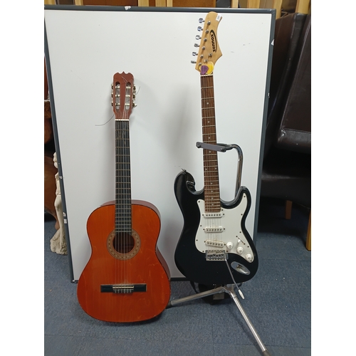 197 - A pair of guitars to include a Zennox electric guitar untested with a stand and an unbranded acousti... 