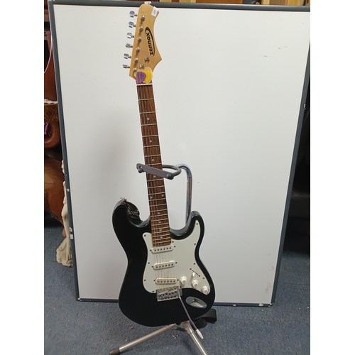 197 - A pair of guitars to include a Zennox electric guitar untested with a stand and an unbranded acousti... 