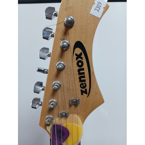 197 - A pair of guitars to include a Zennox electric guitar untested with a stand and an unbranded acousti... 