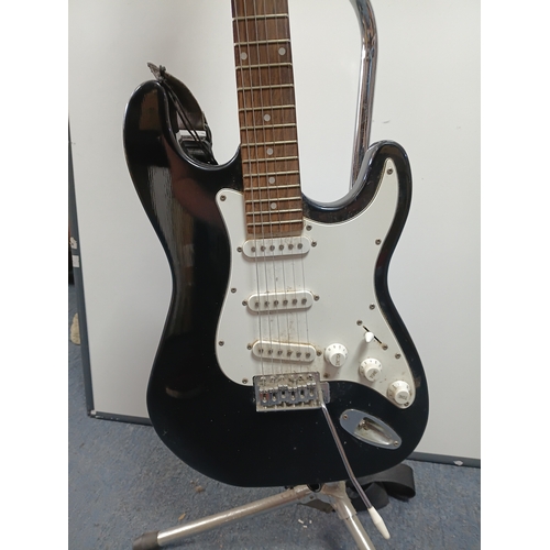 197 - A pair of guitars to include a Zennox electric guitar untested with a stand and an unbranded acousti... 