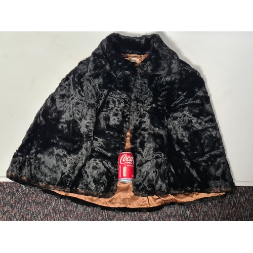 238 - A vintage 1950's John Orton Furrier ladies black fur cape. 53cm drop from button to bottom edge.