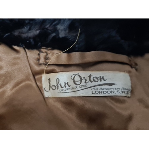 238 - A vintage 1950's John Orton Furrier ladies black fur cape. 53cm drop from button to bottom edge.