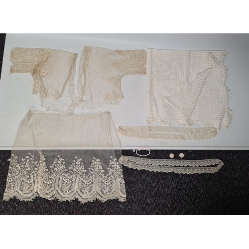 241 - A collection of vintage lace items to include a netted dress (in parts), a white tablecloth which me... 