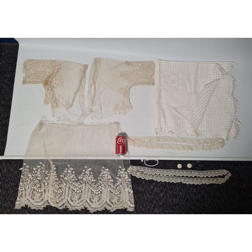 241 - A collection of vintage lace items to include a netted dress (in parts), a white tablecloth which me... 