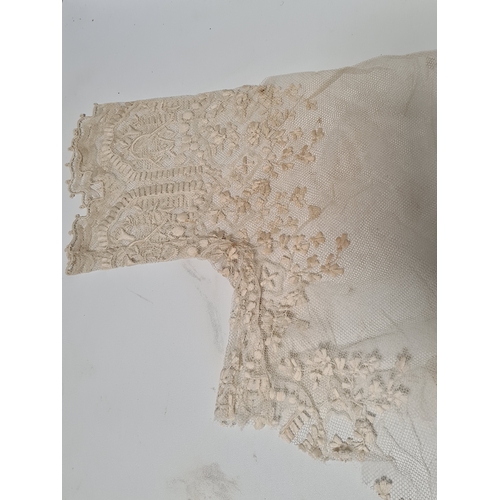 241 - A collection of vintage lace items to include a netted dress (in parts), a white tablecloth which me... 