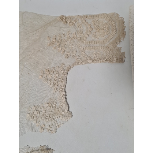 241 - A collection of vintage lace items to include a netted dress (in parts), a white tablecloth which me... 
