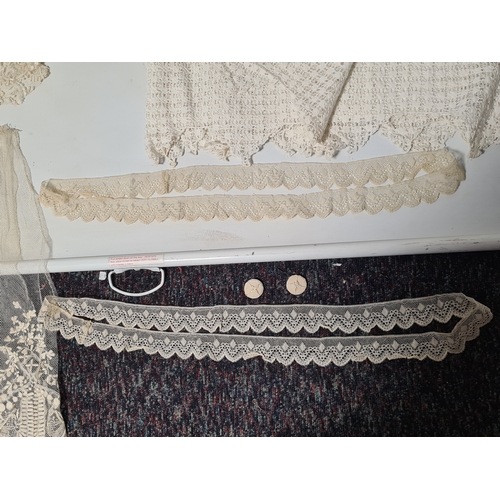 241 - A collection of vintage lace items to include a netted dress (in parts), a white tablecloth which me... 