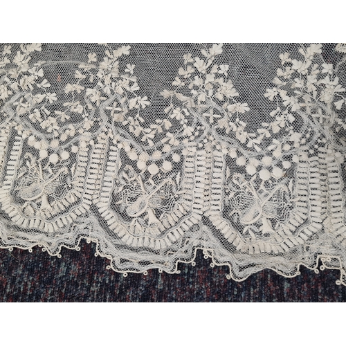 241 - A collection of vintage lace items to include a netted dress (in parts), a white tablecloth which me... 