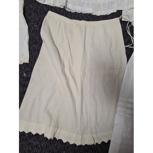298 - A collection of 5 Victorian & Edwardian white underskirts & slips. Some have lace detailing