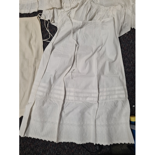 298 - A collection of 5 Victorian & Edwardian white underskirts & slips. Some have lace detailing