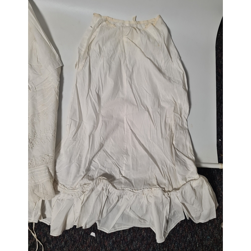 298 - A collection of 5 Victorian & Edwardian white underskirts & slips. Some have lace detailing