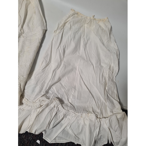 298 - A collection of 5 Victorian & Edwardian white underskirts & slips. Some have lace detailing