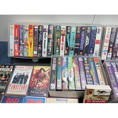 12 - A large collection of VHS video cassettes containing classic films, action films and music recording... 