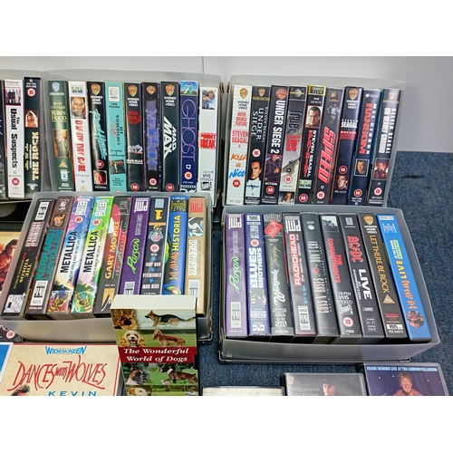 12 - A large collection of VHS video cassettes containing classic films, action films and music recording... 