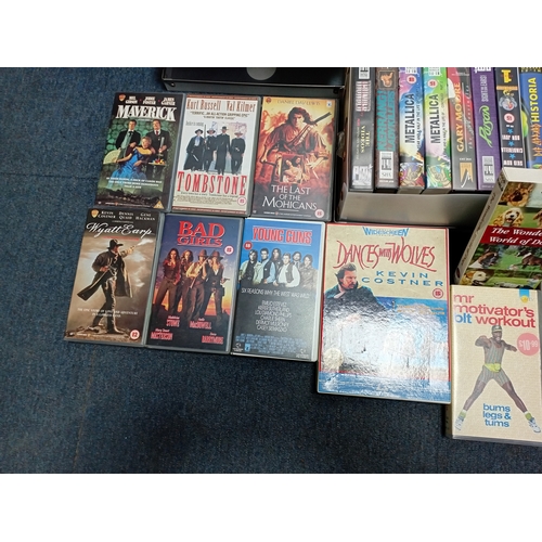 12 - A large collection of VHS video cassettes containing classic films, action films and music recording... 