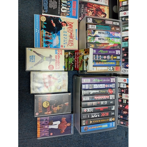 12 - A large collection of VHS video cassettes containing classic films, action films and music recording... 