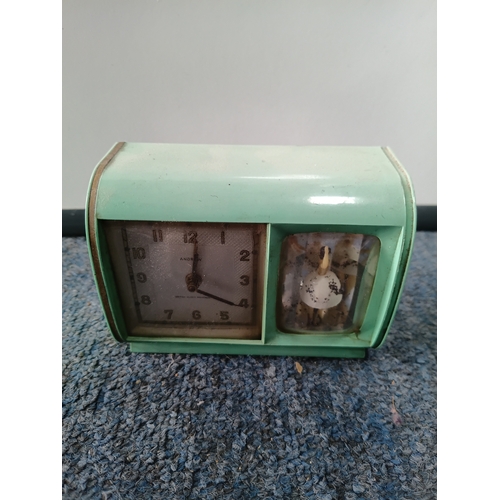 23 - A pair of mantle clocks to include, a rare vintage mid-century money box savings mantel clock and a ... 