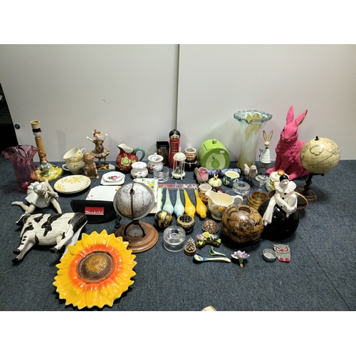 37 - A job lot of ceramic items to include, vases, cups figurines, spoons and more. The largest item meas... 