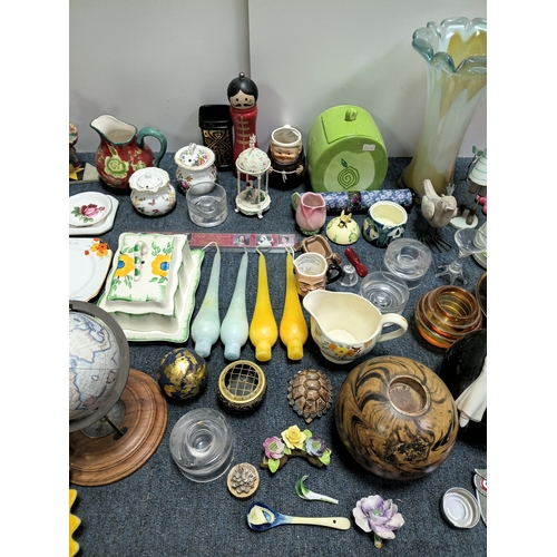 37 - A job lot of ceramic items to include, vases, cups figurines, spoons and more. The largest item meas... 