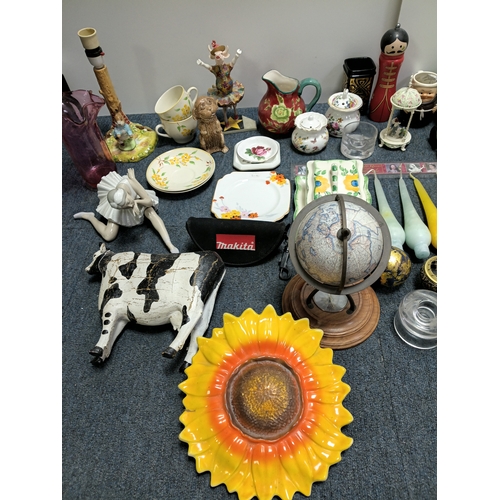 37 - A job lot of ceramic items to include, vases, cups figurines, spoons and more. The largest item meas... 