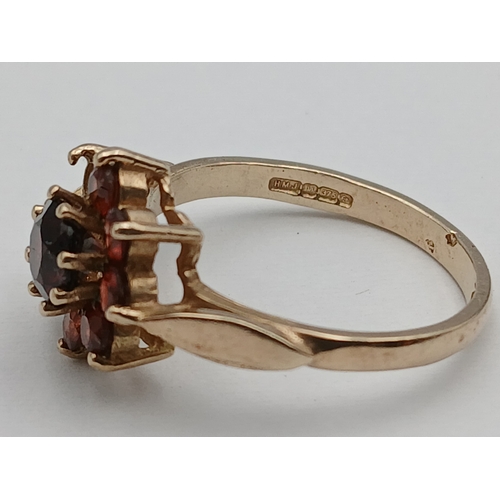 401 - A hallmarked 375 9ct gold cluster ring set with red stones - 1 missing. Size N-