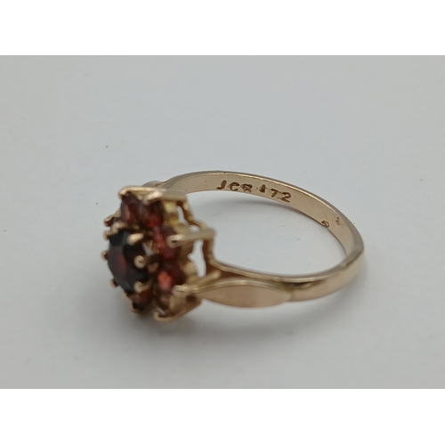 401 - A hallmarked 375 9ct gold cluster ring set with red stones - 1 missing. Size N-
