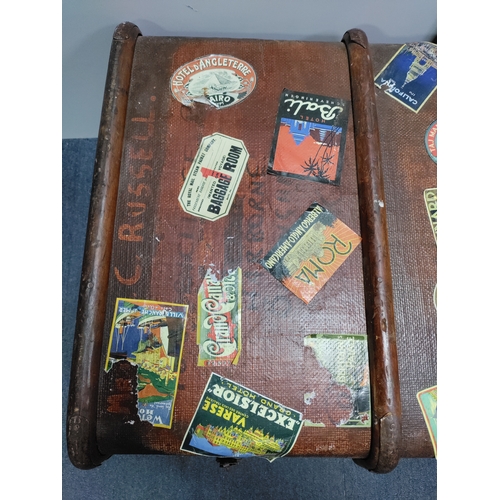 302 - A collectable vintage steamer trunk featuring various travel stickers from destinations like Rome an... 