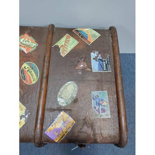 302 - A collectable vintage steamer trunk featuring various travel stickers from destinations like Rome an... 