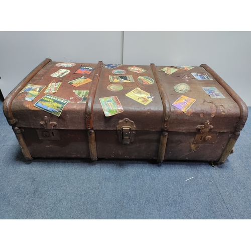 302 - A collectable vintage steamer trunk featuring various travel stickers from destinations like Rome an... 