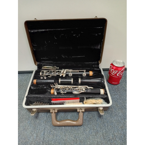 200 - A vintage Buescher wooden clarinet stored in a protective case with a cleaning kit
