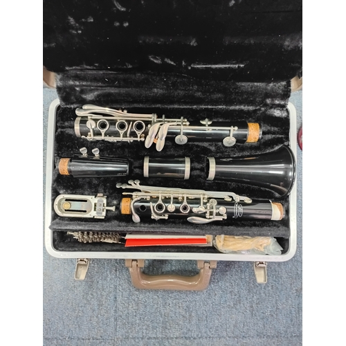 200 - A vintage Buescher wooden clarinet stored in a protective case with a cleaning kit