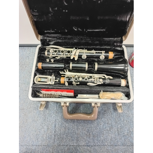 200 - A vintage Buescher wooden clarinet stored in a protective case with a cleaning kit